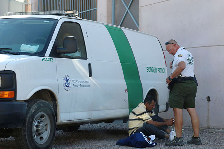 03082014 - A man ties his shoes while being detained by Border Patrol at the Morley Port of Entry in Nogales, Ariz. Photo by Alec Damiano / JMC 351