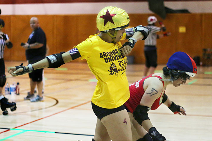 03222014 - Sigmund Droid (cq), 22, of the ASU Derby Devils blocks one of the UA Derby Cats during a match held in Mesa, Ariz. This was ASU's first roller derby match, albeit without a complete team. ASU beat the Derby Cats, 261-102. Photo by Alec Damiano / JMC 351